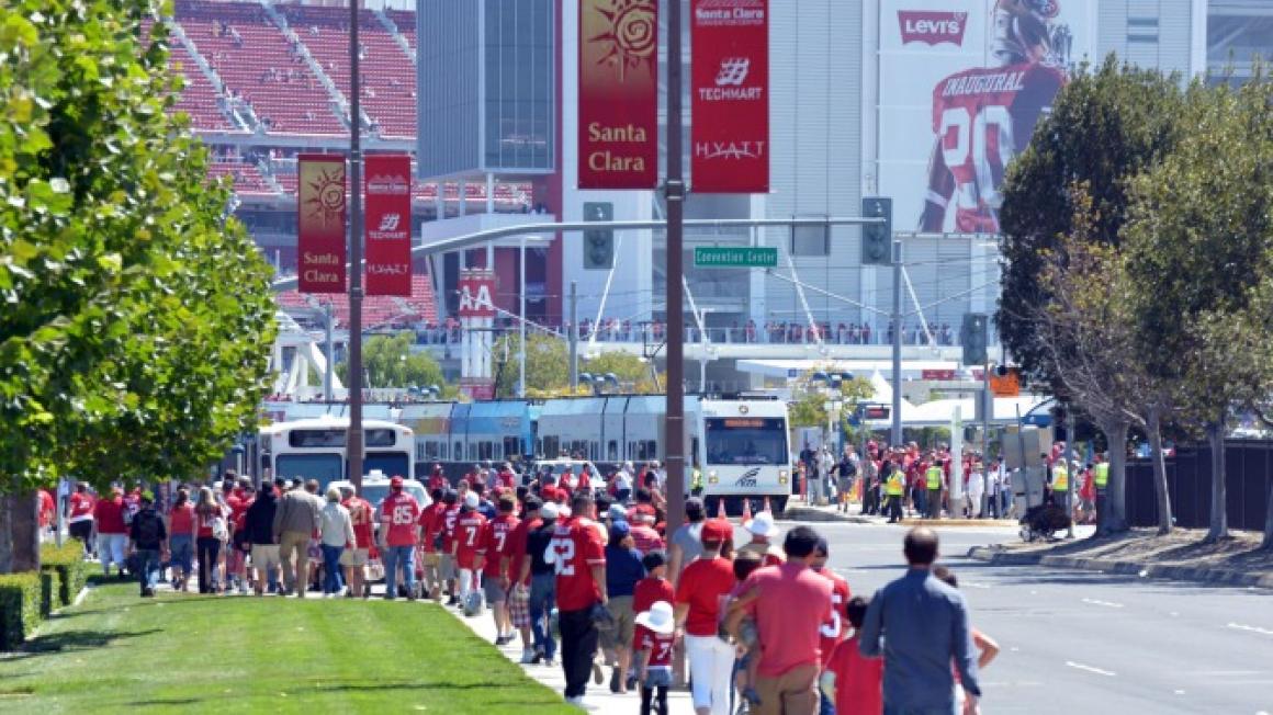 People walking with Levi's Stadium in the background