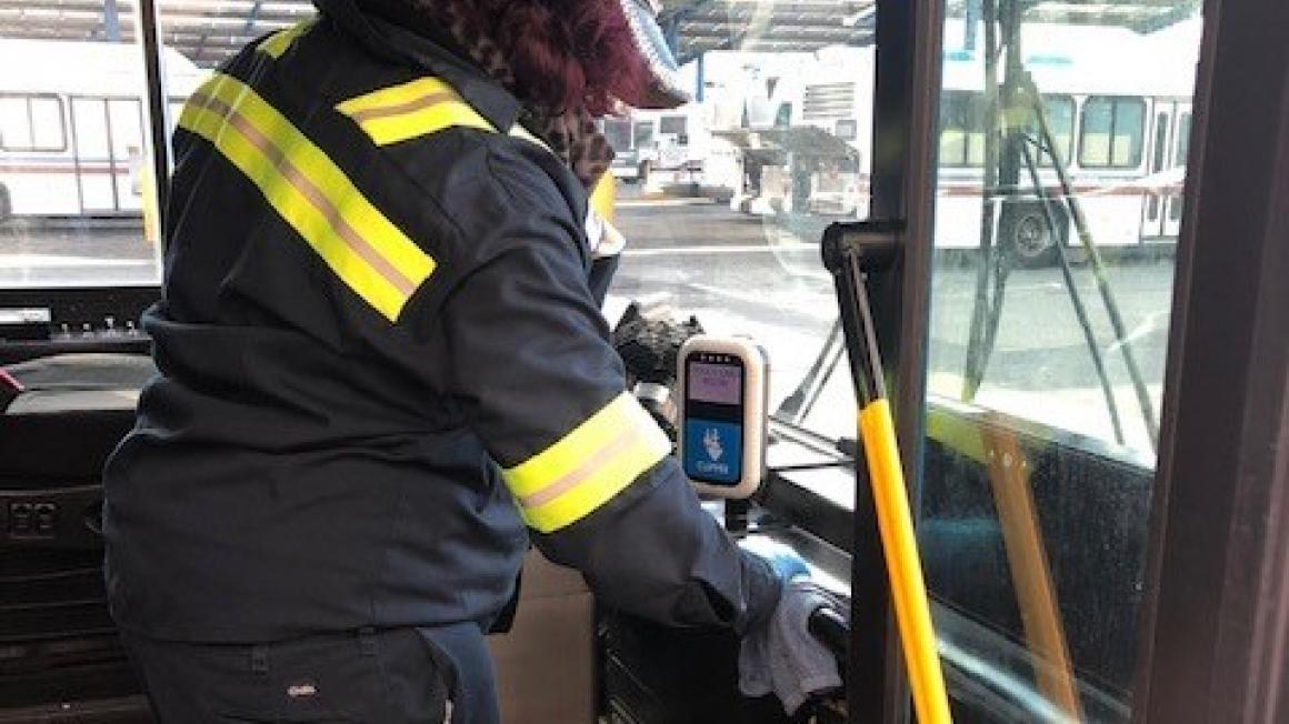 maintenance worker cleaning bus