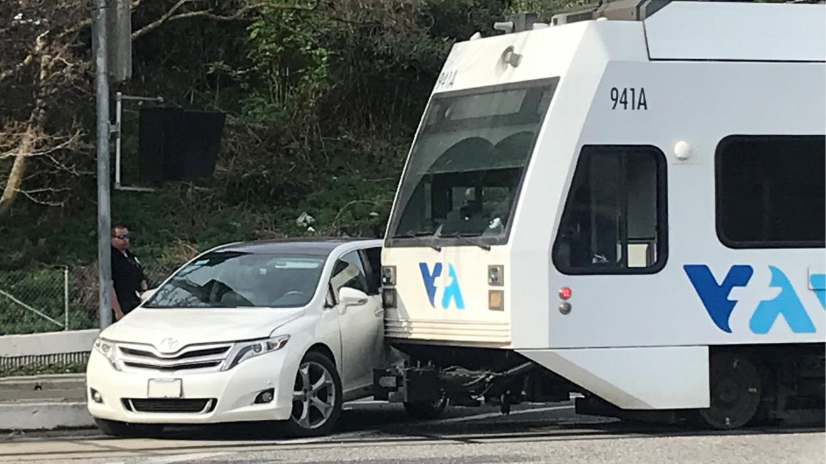 car makes left turn in front of VTA train