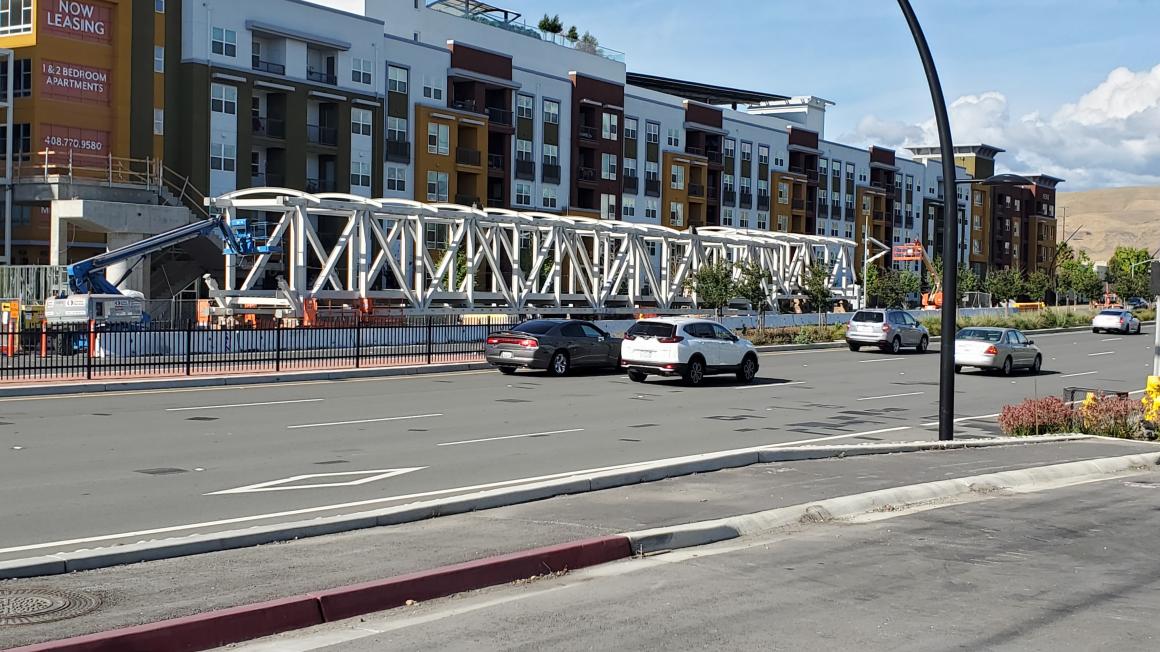 The giant steel truss for the Milpitas Transit Center overcrossing awaits installation