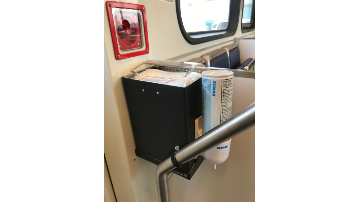Hand sanitizer and mask dispenser on light rail train