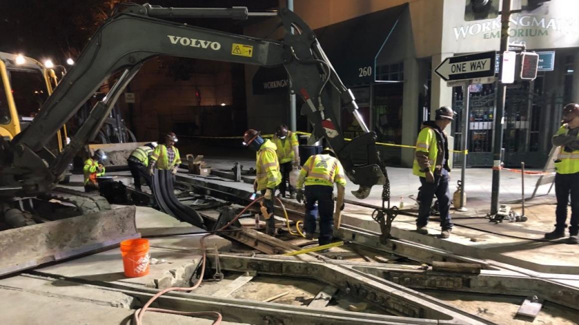 Crews perform light rail track maintenance