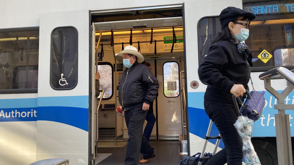 people exiting light rail train