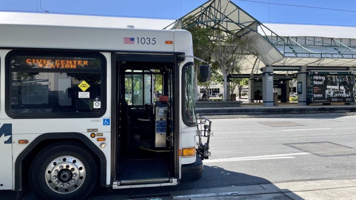 bus parked in front of light rail station