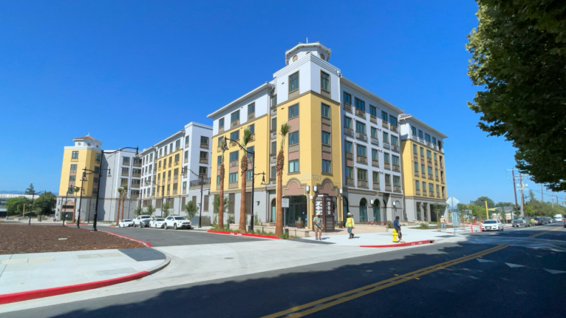blue sky backdrop and new yellow and white apartment building