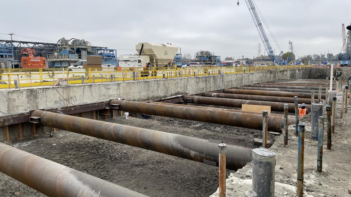 metal pipes across a wide ditch in the ground