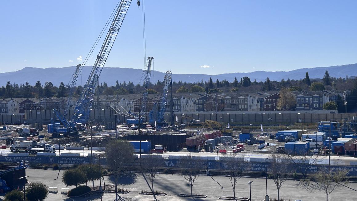 large crain construction site people working