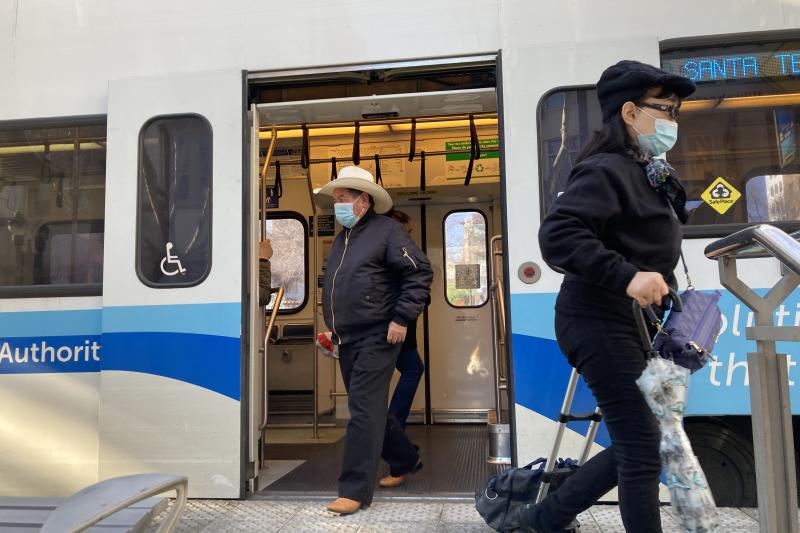 people exiting light rail train
