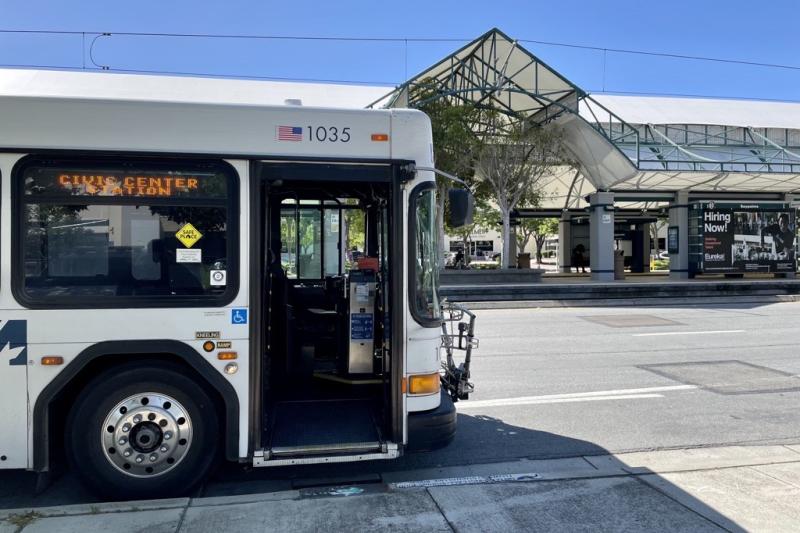 bus parked in front of light rail station