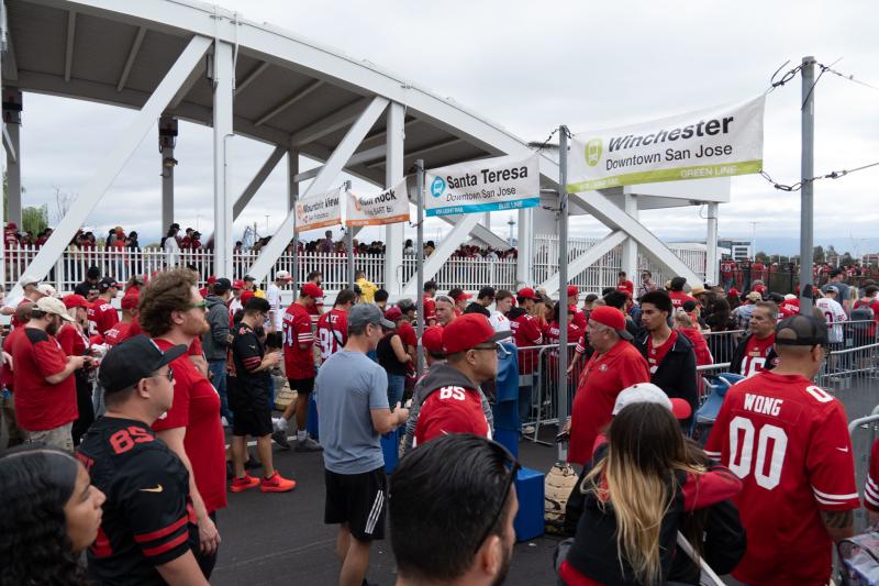 Niner football fans waiting in the VTA queue lines to board the light rail after a Niner game.