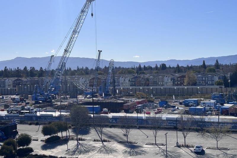 large crain construction site people working