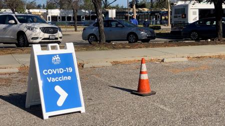 covid vaccine sign at light rail station