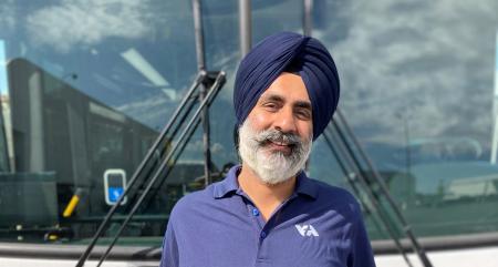 Bus Operator Samarpal Singh poses in front of VTA bus