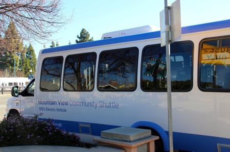 Mountain View Community Shuttle with VTA light rail in background