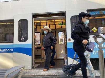 people exiting light rail train