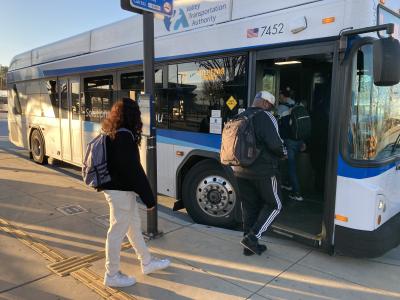 passengers step onto bus