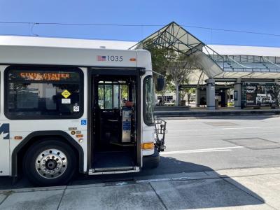 bus parked in front of light rail station