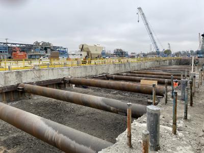 metal pipes across a wide ditch in the ground