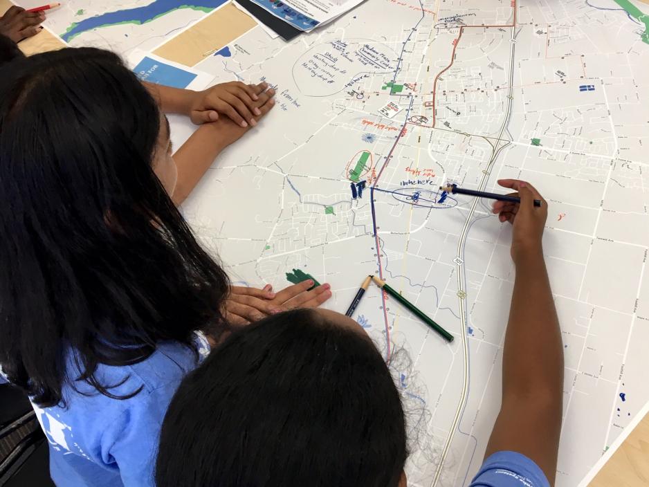 teenagers examining transportation map