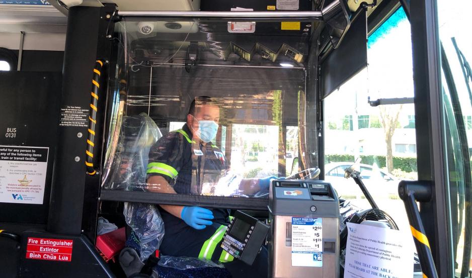 VTA bus operator demonstrating pull-down safety barrier screen