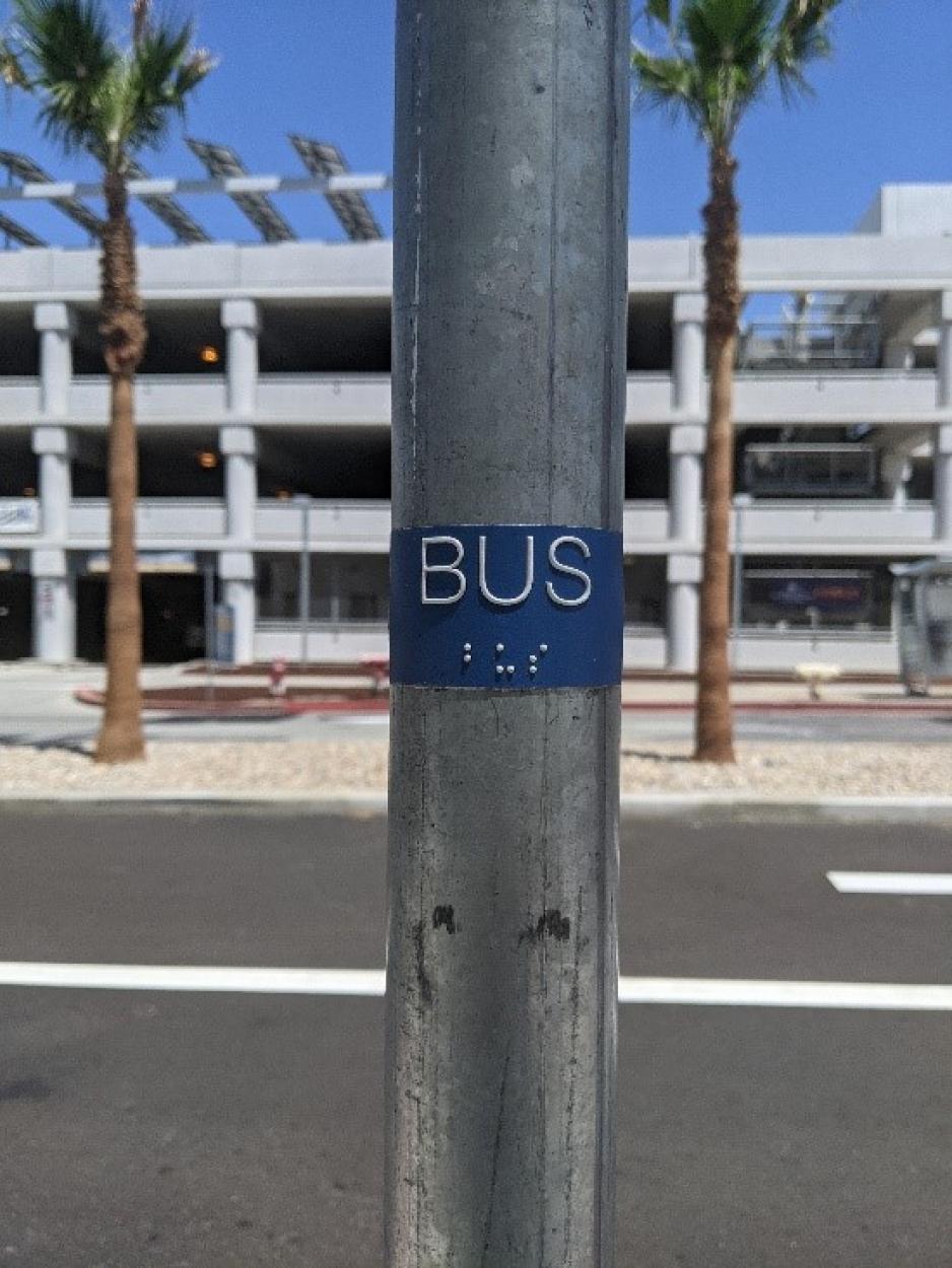 Image of braille placard on bus stop pole