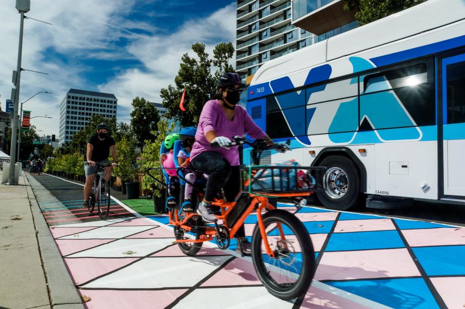 Cyclists ride alongside VTA bus at Viva Calle