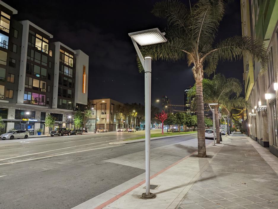 A photo of close street lights on the sidewalk.