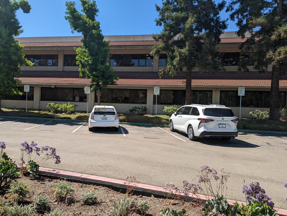 A photo of a parking lot with multiple three hour parking spots. 