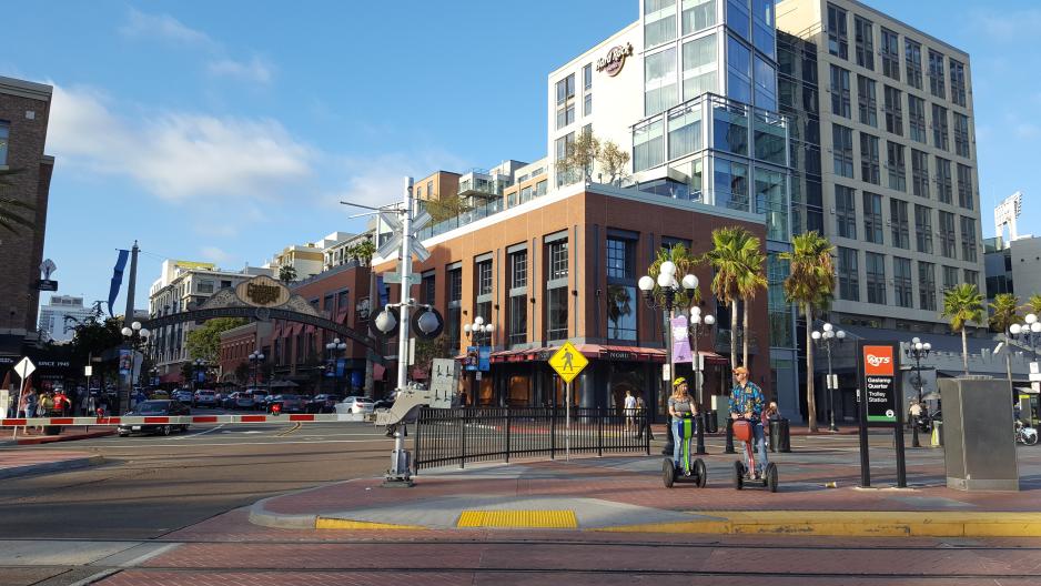 A photo of a commercial center with a trolley station.
