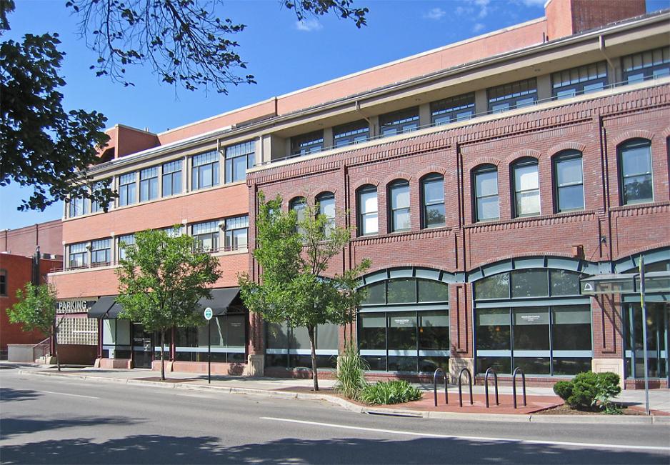 A photo of a brick parking garage that blends blends in with adjacent development. 