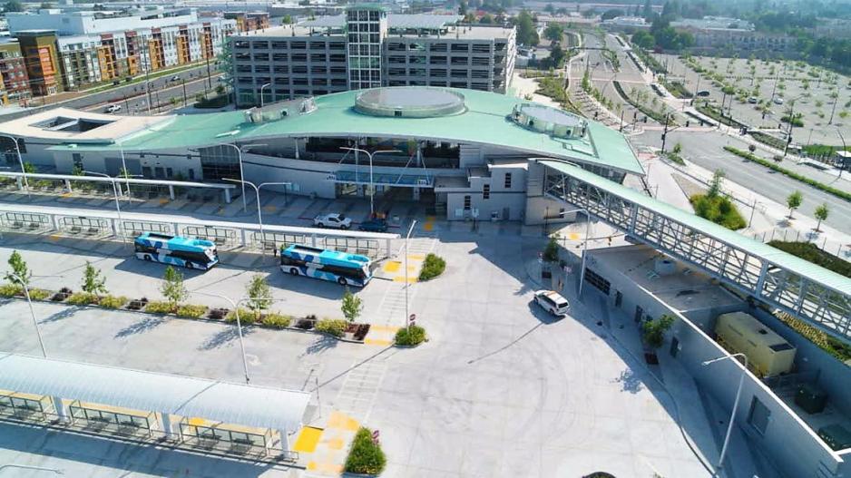 An aerial photo showing a transit center with buses and rail.