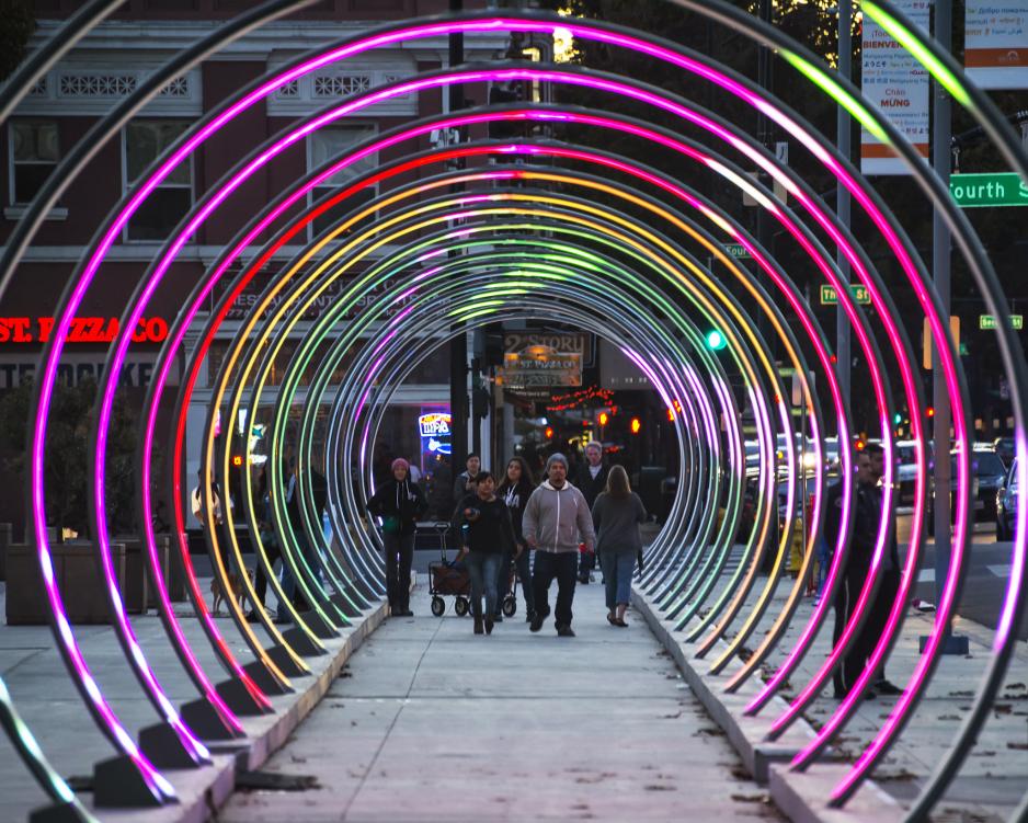 A photo of a row of light up rings that people can walk through.