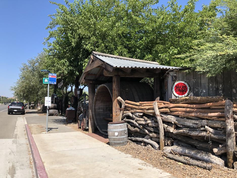 A push stop with a barrel and wood shelter.