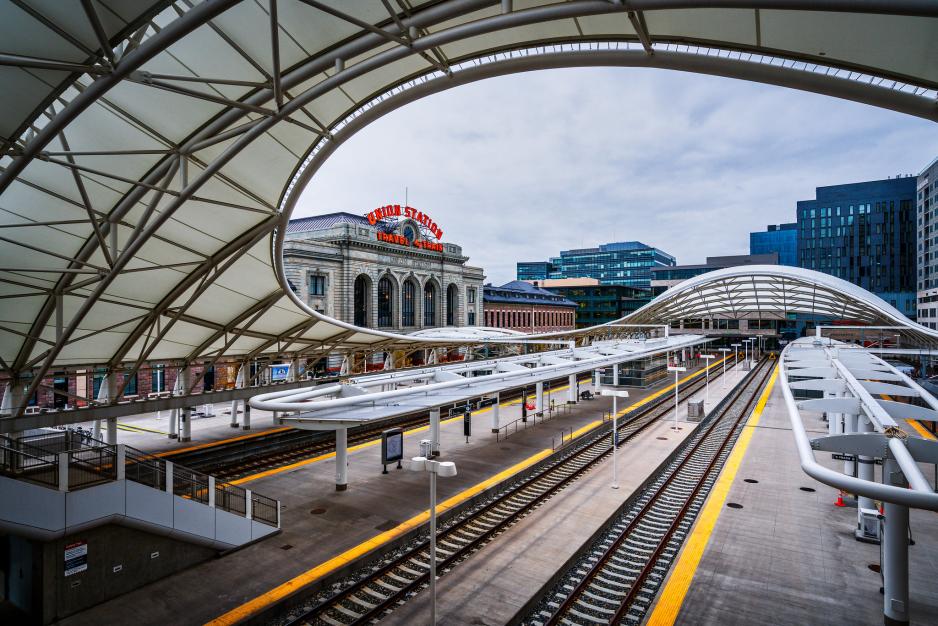 A photo of an elevated train track with office buildings in the distance. 