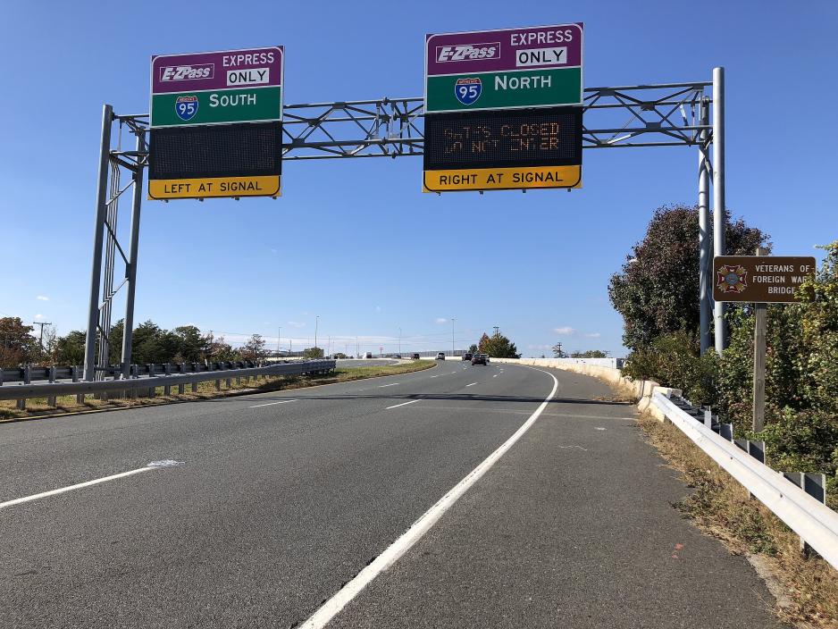 Photo of colorful express signs over an empty two-lane freeway 
