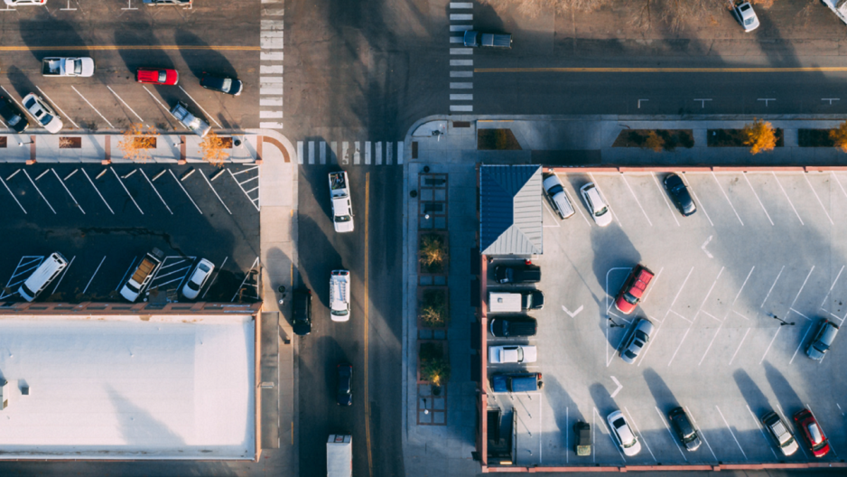 Photo taken from above showing an intersection with on-street, garage, and parking lot parking