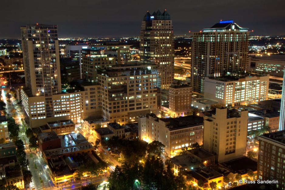 Photo from above of many buildings in downtown Orlando at night