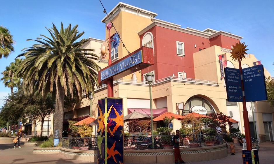 A photo of a mixed-use building with a plaza at Fruitdale Village.