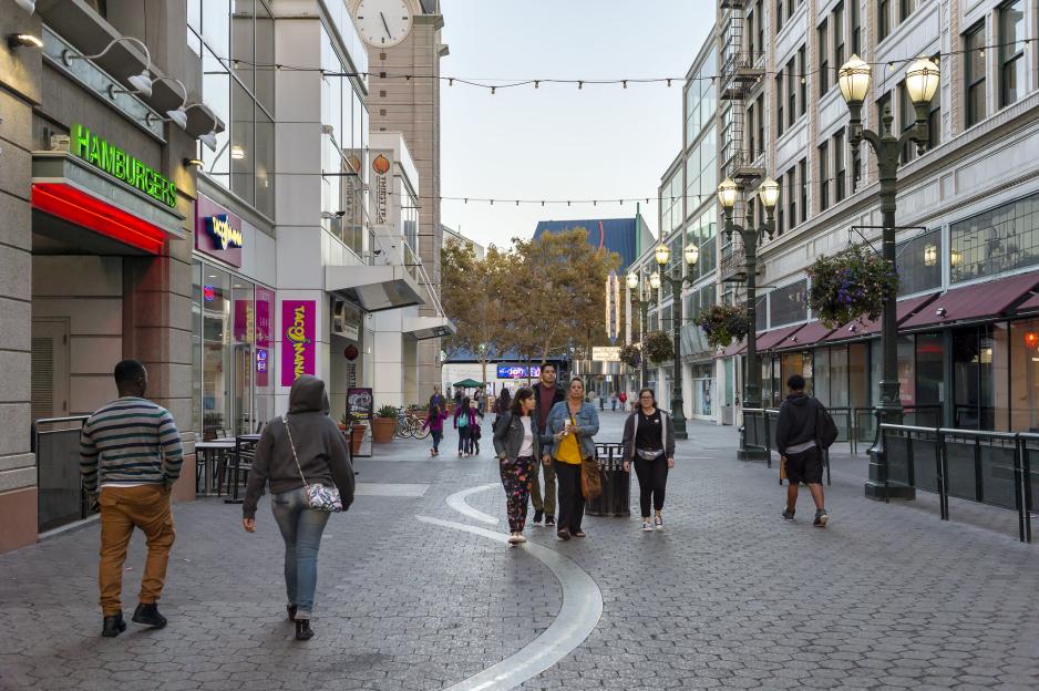 A photo of a commercial center with people walking.