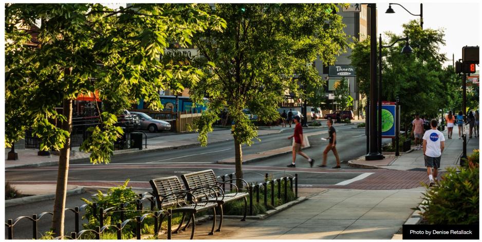 A photo of a main street with a people walking.