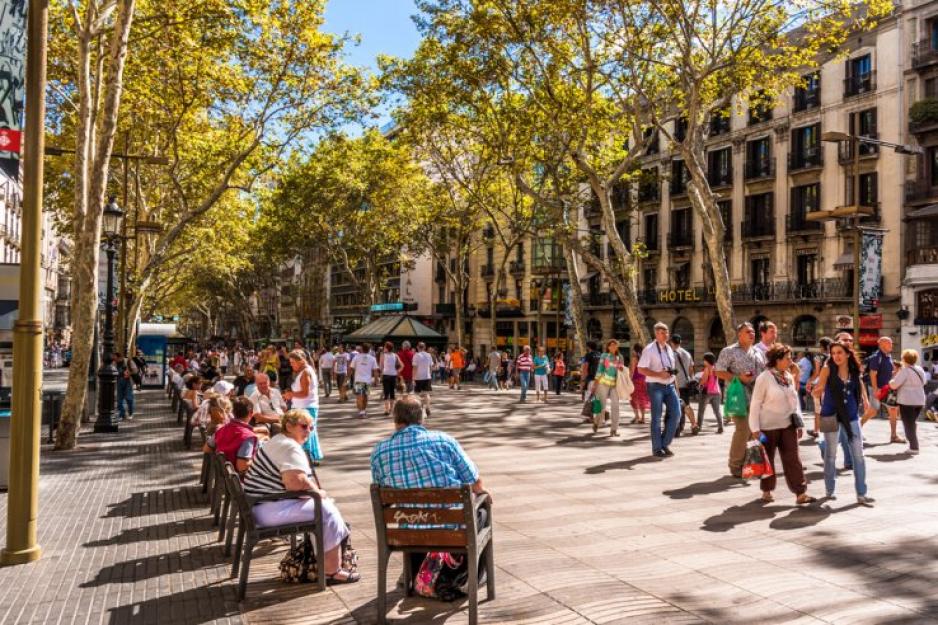 A photo of a plaza with seating full of people.