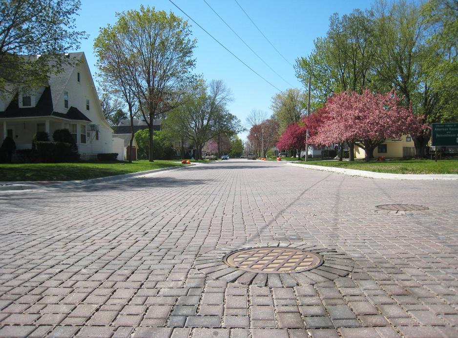 Photograph of road with permeable pavement (looks like cobblestones.)