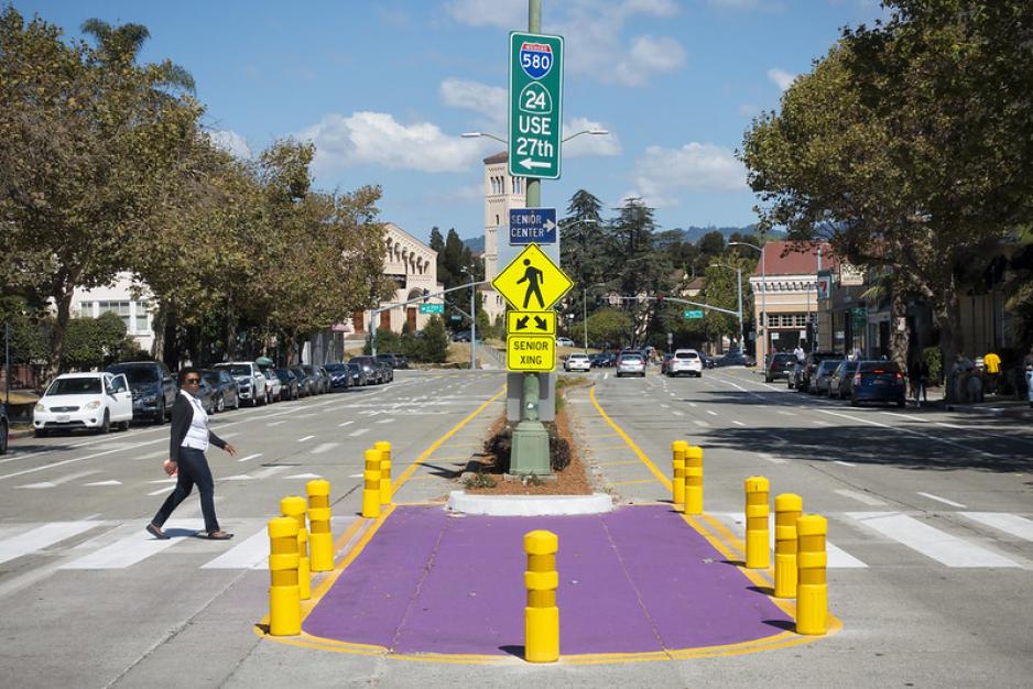 A photo of a colorful crosswalk with a sign that says "Senior Xing"