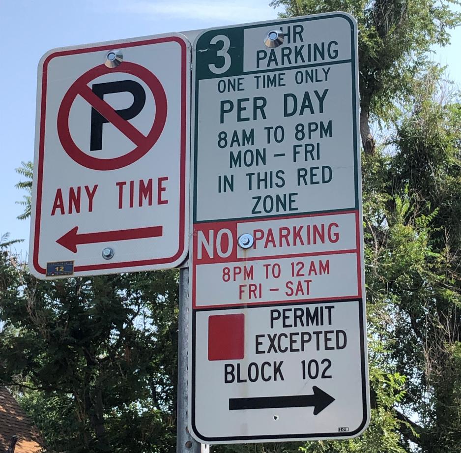 Photo of several parking regulation signs