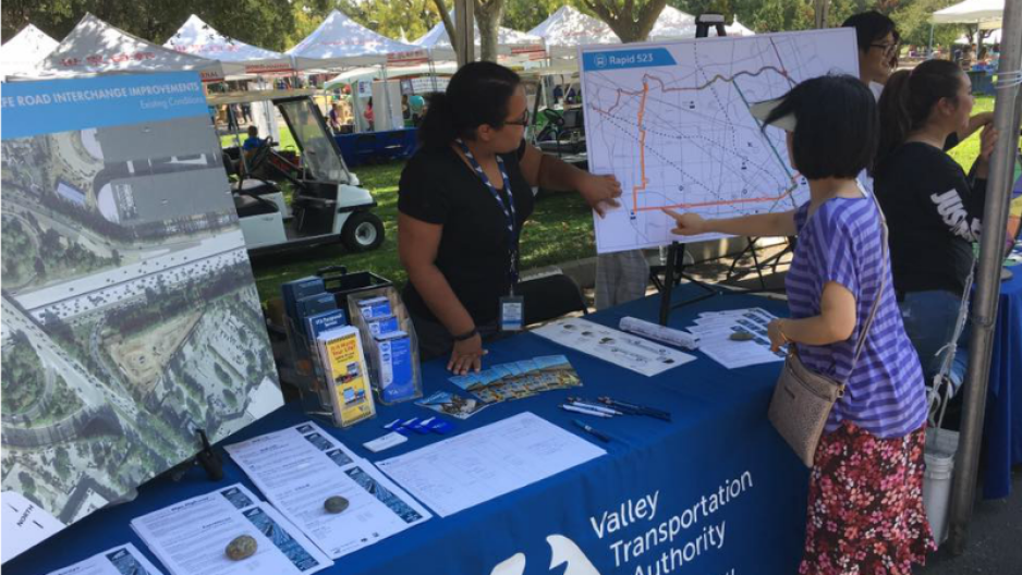 A VTA Employee sharing information at a tabling event