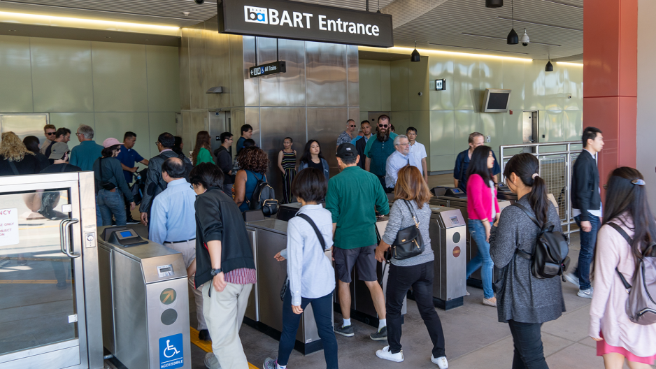 riders going through faregates at BART station 