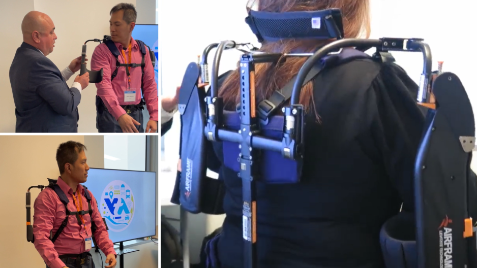 Attendees try on the exoskeleton