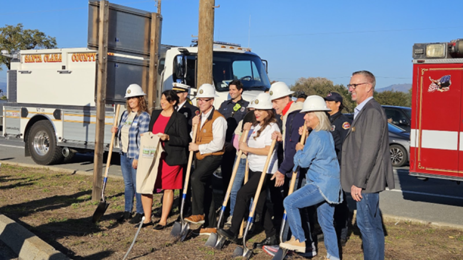 group of people with shovels posing for camera