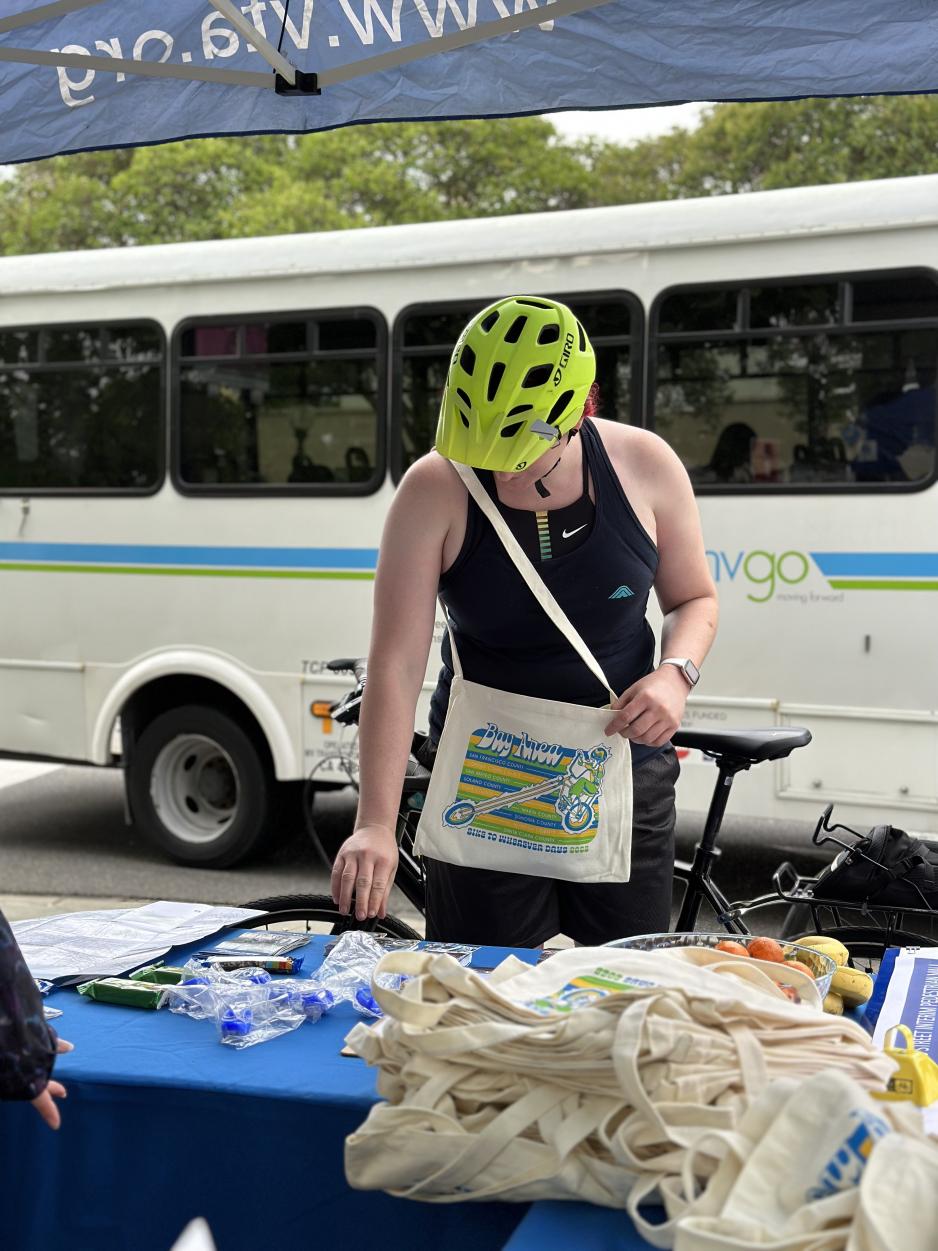 bicyclist looking at information on a table